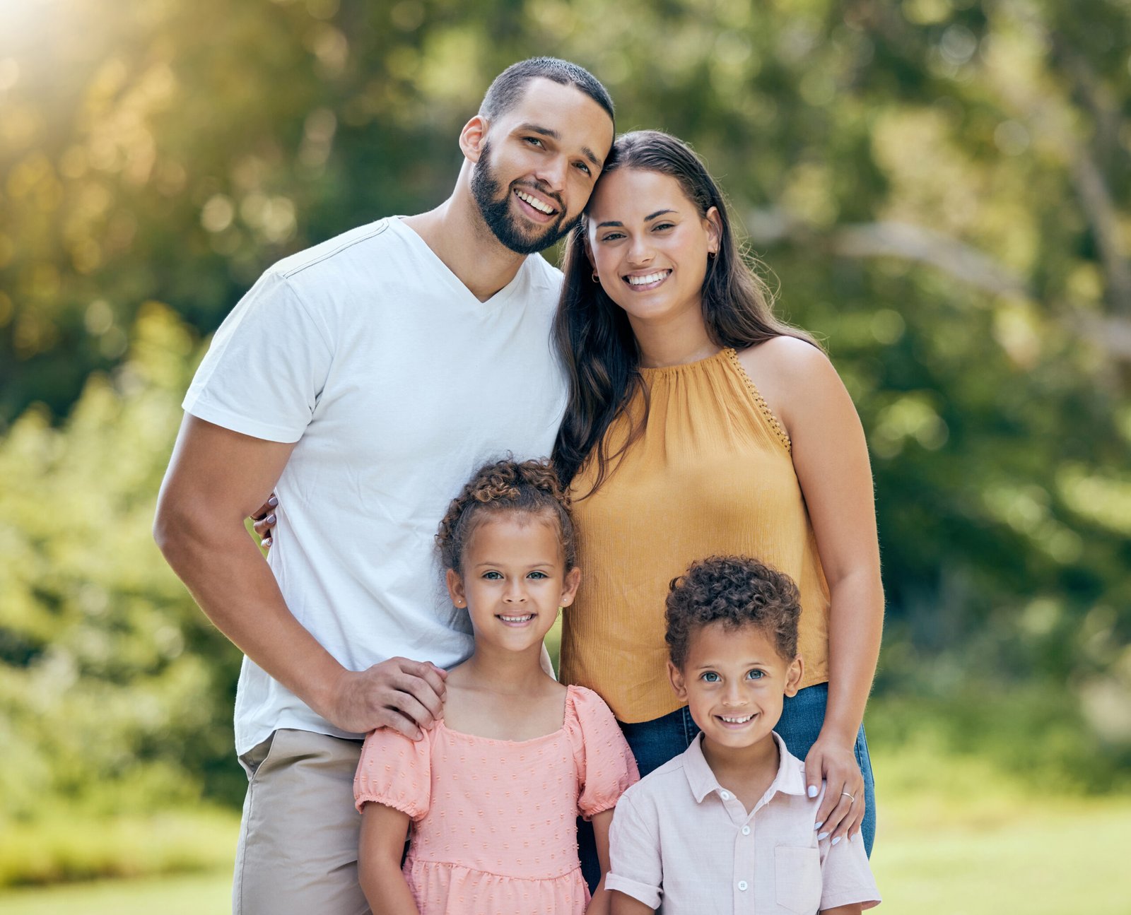 Family, children and garden with a girl, boy and parents outdoor together in the yard on a summer d.